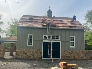 Franco Roofing Inc. crew replacing asphalt shingle roof on a two-story colonial home in Bucks County, PA