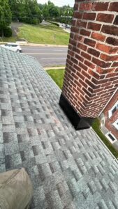 GAF asphalt shingles installed near a brick chimney in Doylestown, PA
