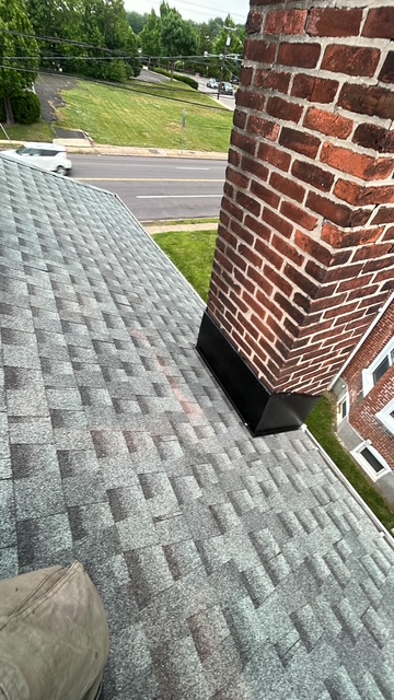 GAF asphalt shingles installed near a brick chimney in Doylestown, PA