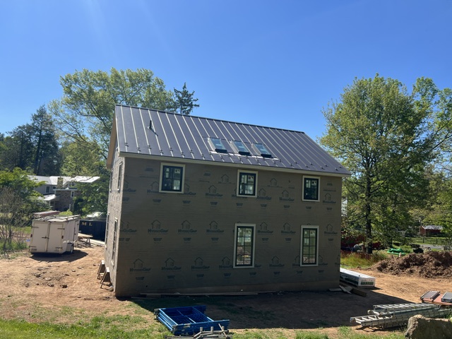 Black standing seam metal roof on a new home in Buckingham, Pennsylvania